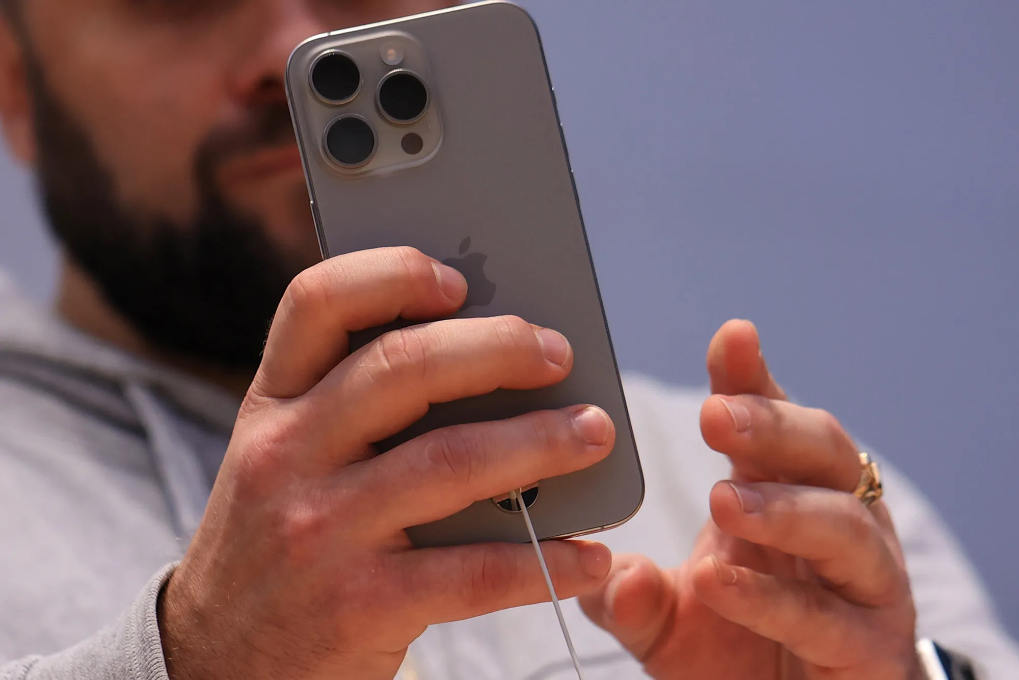 An Apple customer uses an iPhone 15 Pro.