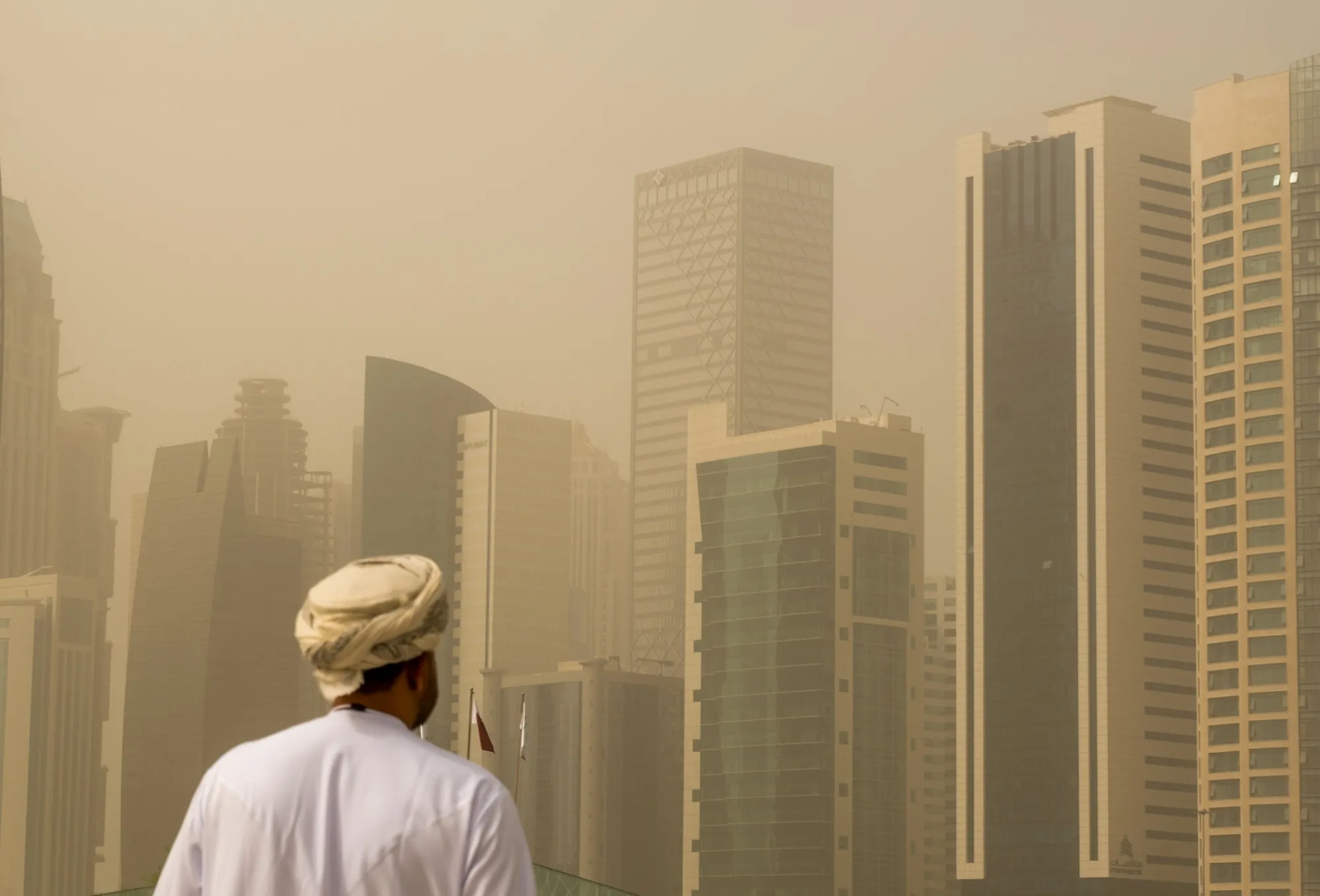 A man walks amidst a heavy sandstorm in Doha, Qatar, on April 15, 2025.