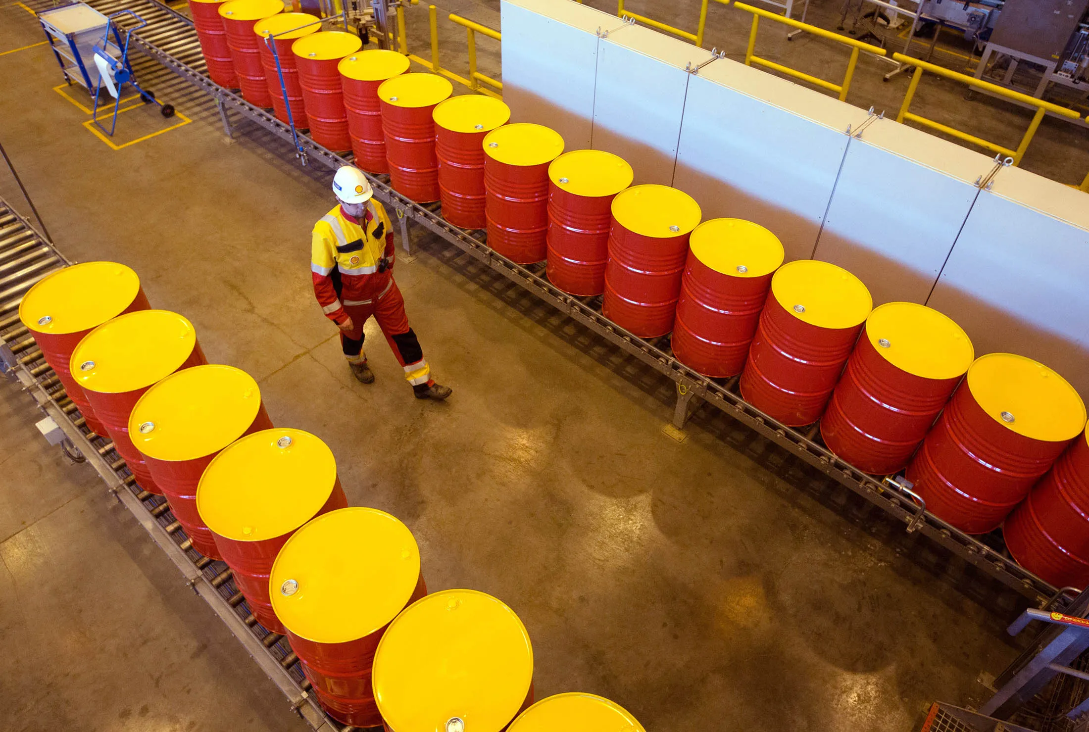 Oil drums containing lubricant oil sit on a conveyor belt at a Royal Dutch Shell plant in Torzhok, Russia.
