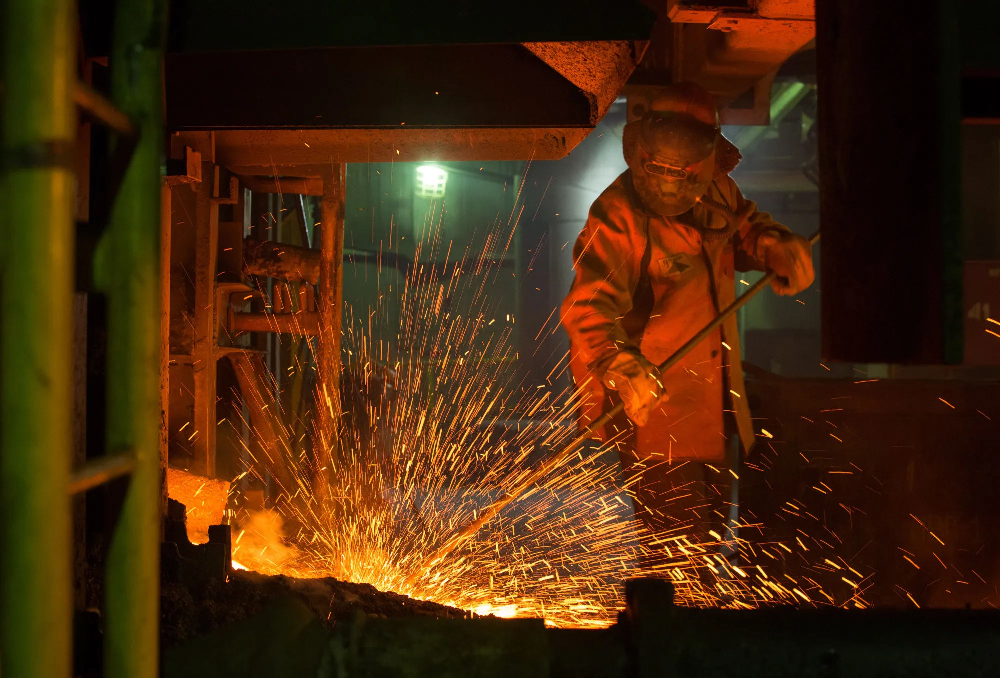 A worker checks&nbsp;the flow of hot liquid metal&nbsp;from a furnace at a Nornickel plant&nbsp;in Norilsk, Russia.
