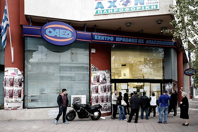 Job seekers wait outside an employment center in Thessaloniki, Greece, on Nov. 13