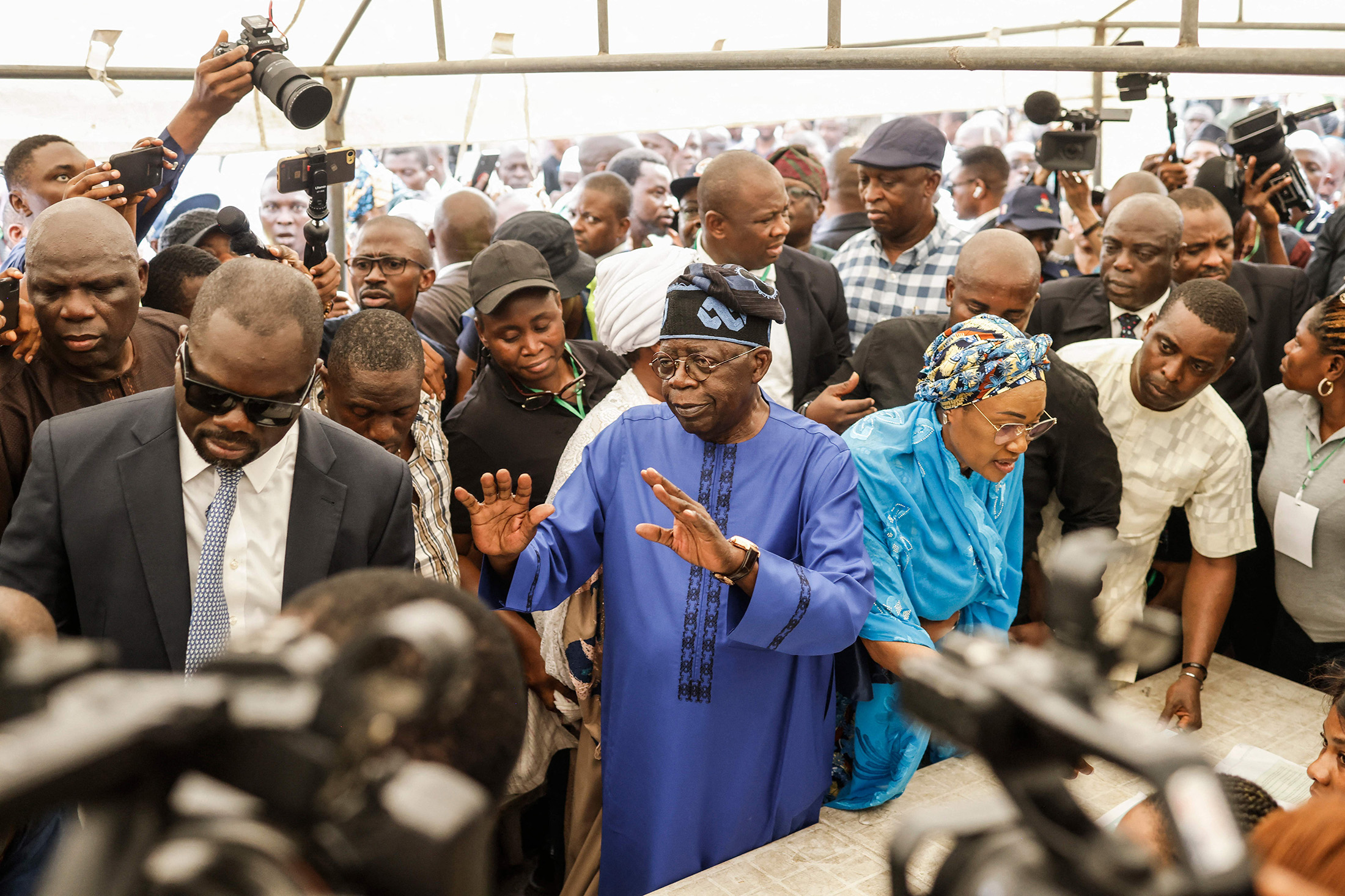 Bola Tinubu, center, arrives at a polling station in Lagos on Feb. 25, 2023.