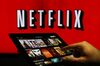 A man scrolls through a selection of viewing choices on the Netflix Inc. application on a tablet device in this arranged photograph in London, U.K., on Tuesday, Jan. 5, 2016. Netflix Inc., which delivered the best return of any stock in the S&P 500 last year, has ambitious plans for this year so it can produce something new next year: serious profits.