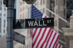 A Wall Street sign is displayed in front of the New York Stock Exchange (NYSE) in New York, U.S., on Friday, May 25, 2018.
