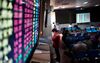 TOPSHOT - In this photo taken on December 15, 2015, an investor monitors screens showing stock market movements at a brokerage house in Shanghai. A quarter of a century after it opened for business, the Shanghai exchange as a whole has more than 1,000 listed firms, nearly 100 million investors -- more than the membership of the Communist party -- and a total market capitalisation of 4.5 trillion USD. AFP PHOTO / JOHANNES EISELE / AFP / JOHANNES EISELE (Photo credit should read JOHANNES EISELE/AFP/Getty Images)