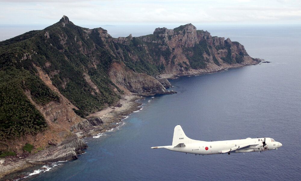 A P-3C patrol plane of Japanese Maritime Self-Defense Force flies over the disputed islets known as the Senkaku islands in Japan and Diaoyu islands in China, in 2011.