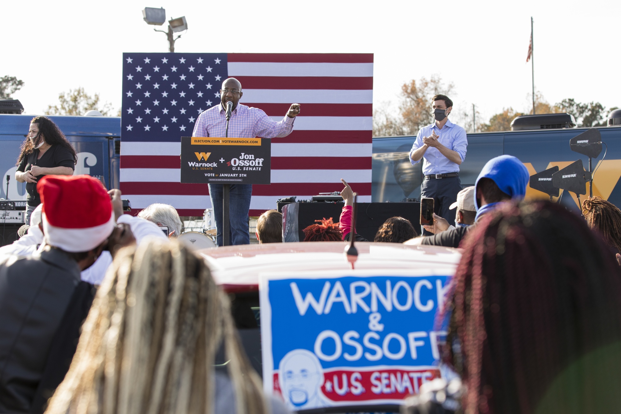 Raphael Warnock, center, and Jon Ossoff attend a rally in Garden City, Georgia on Dec. 19.