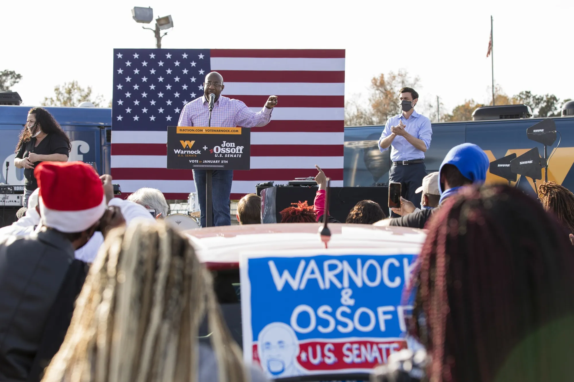 Raphael Warnock,&nbsp;center, and Jon Ossoff attend a&nbsp;rally&nbsp;in Garden City, Georgia&nbsp;on&nbsp;Dec. 19.