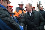 Vladimir Putin meets with construction workers on the construction site of a bridge across the Strait of Kerch, on March 18. The Russian government plans to build a bridge linking mainland Russia to Crimea.
