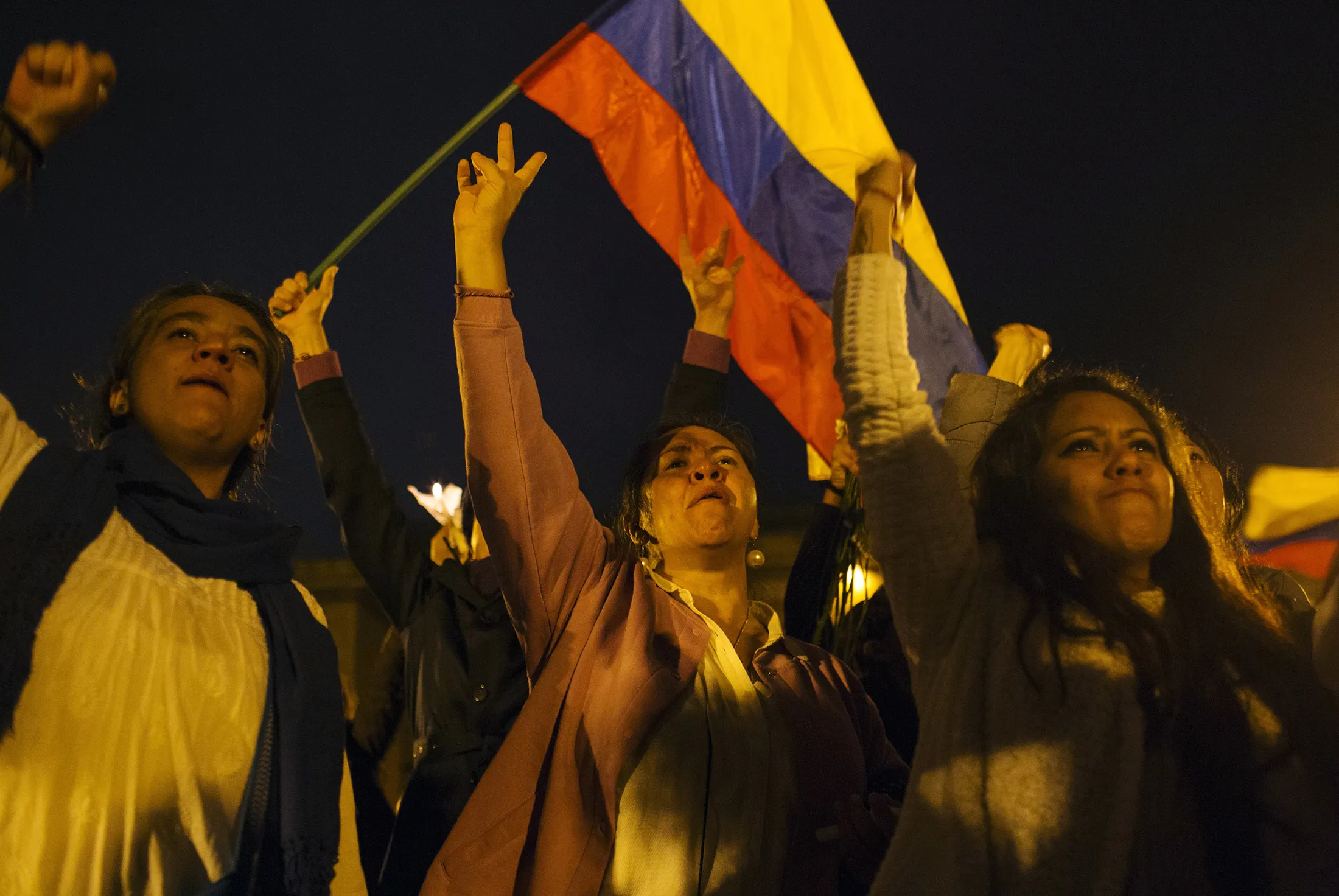 Demonstrators gesture as they wave a Colombian flag during a protest against the failed plebiscite for a peace deal with the Revolutionary Armed Forces of Colombia (FARC) in Bogota, Colombia, on Wednesday, Oct. 5, 2016. Protesters gather even as Juan Manuel Santos, Colombia's president, said Colombia is close to achieving lasting peace with Marxist rebels after a four-hour meeting with his most powerful opponent aimed at salvaging four years of peace talks.