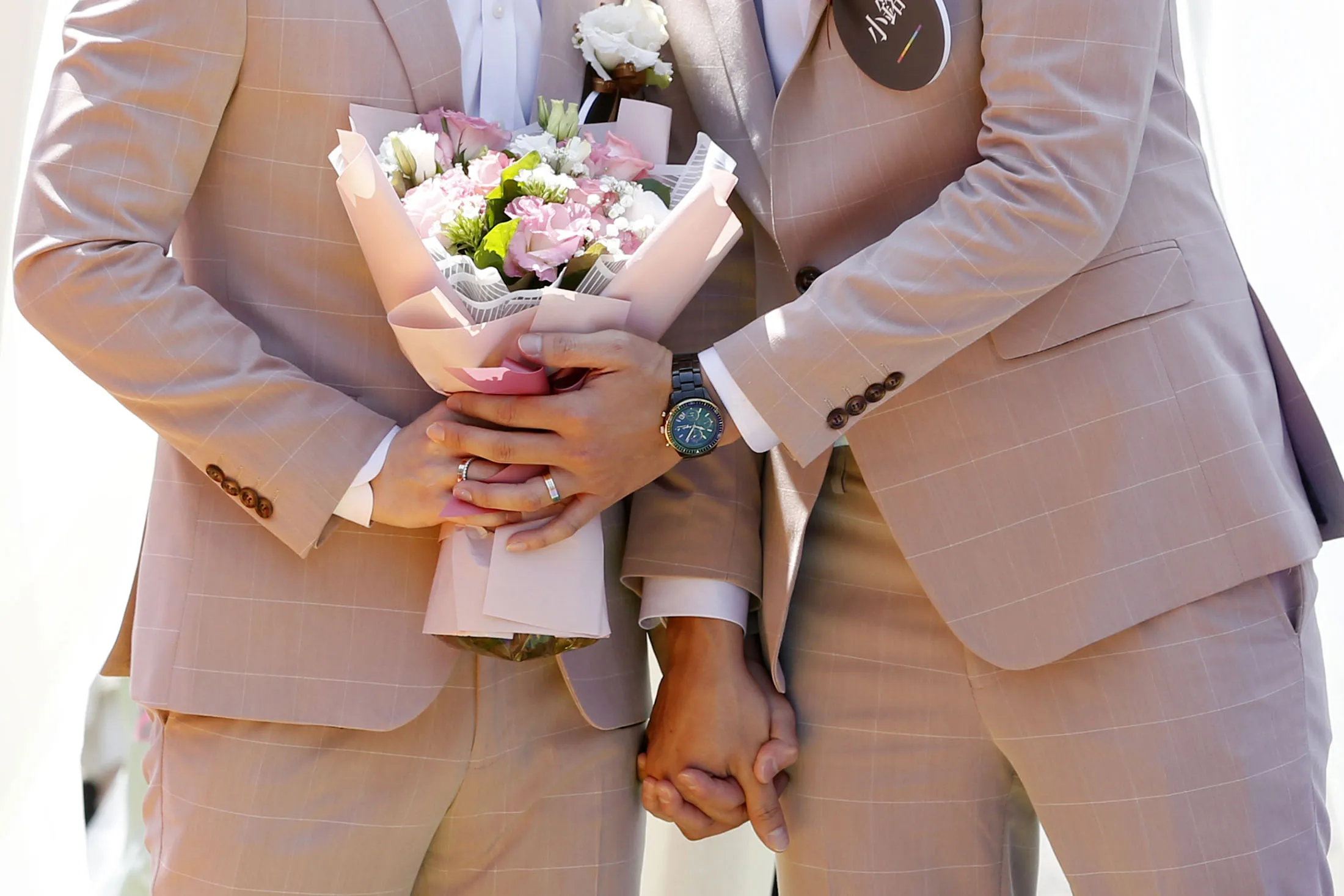A same-sex couple holds a flower bouquet during a pro same-sex marriage party co-organized by the Taipei City government and Marriage Equality Coalition Taiwan in Taipei.