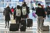 Travelers at Montreal-Pierre Elliott Trudeau International Airport.