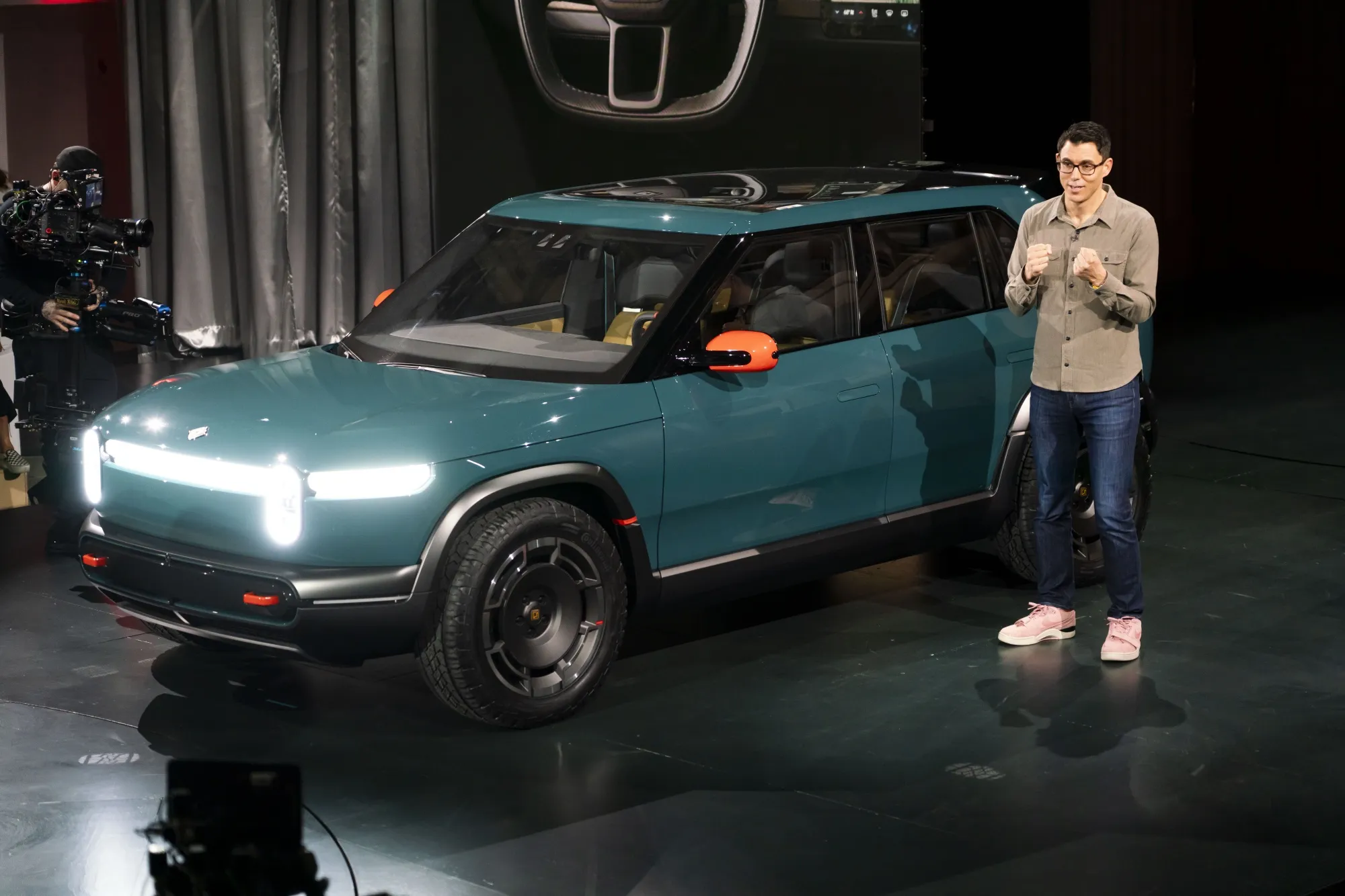 RJ Scaringe, chief executive officer and founder of Rivian Automotive Inc., unveils a Rivian R3X prototype crossover electric vehicle (EV) during an event in Laguna Beach, California, US, on Thursday, March 7, 2024. 
