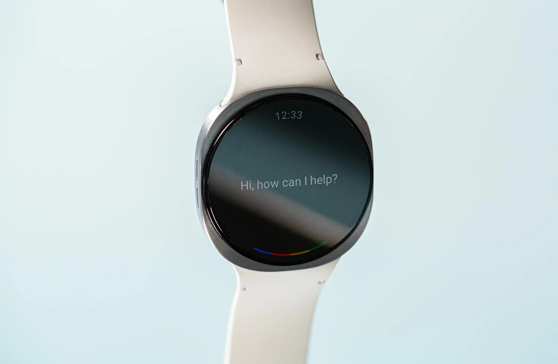 Front view of Samsung’s Galaxy Watch 8, with a message that reads Hi, how can I help?