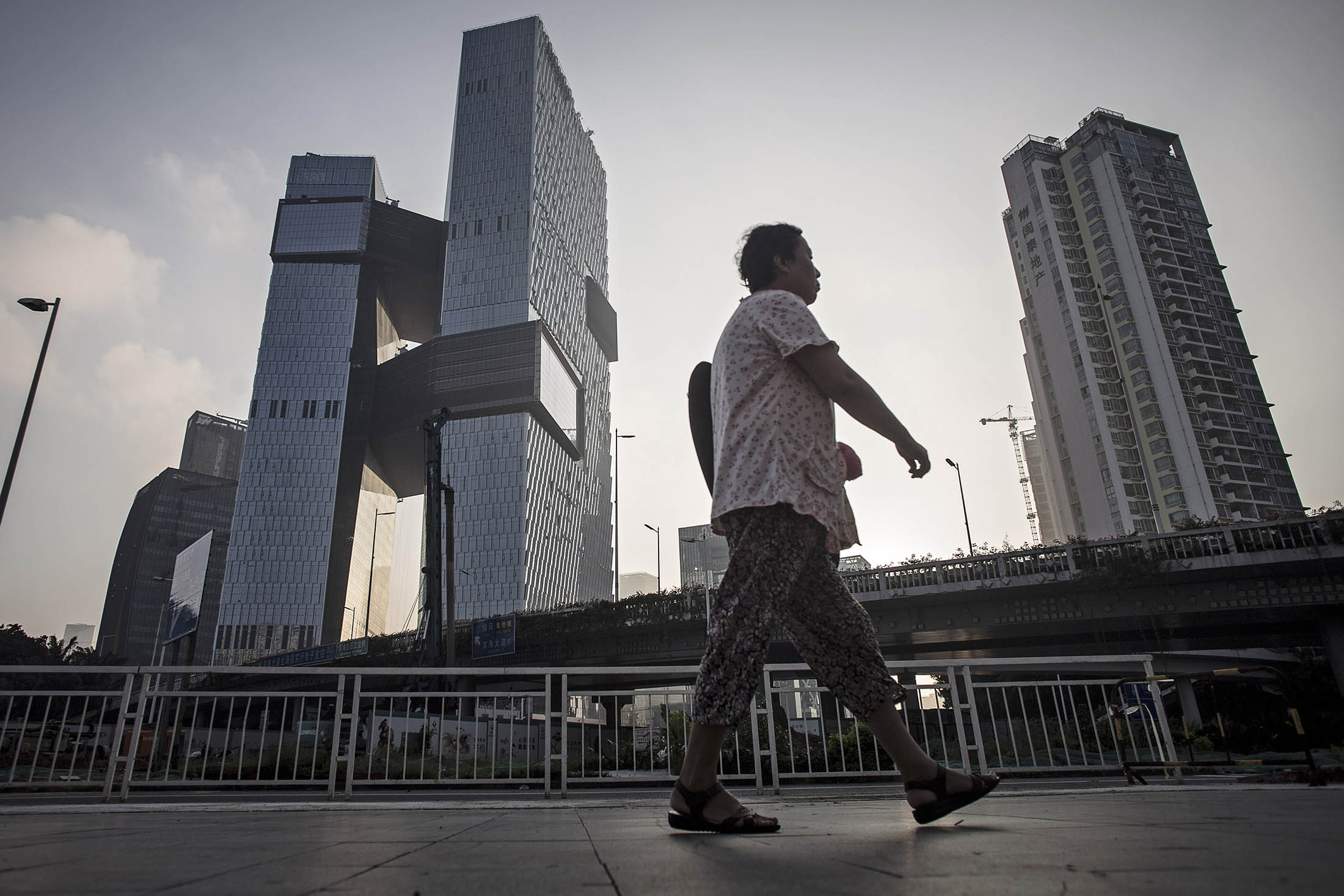 A pedestrian walks past headquarters in Shenzhen, China.
