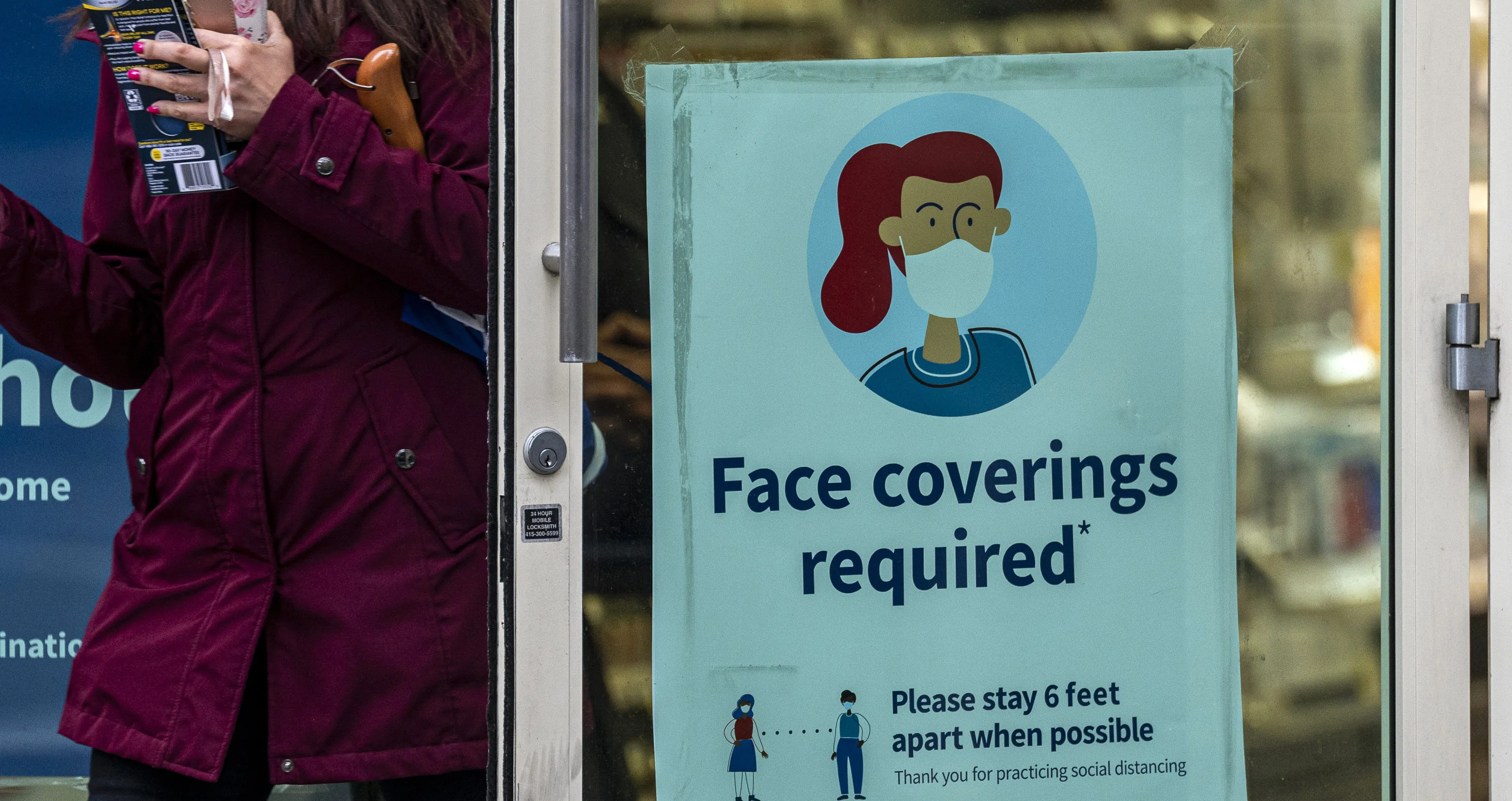 A "face coverings required" sign at a store in San Francisco, California.