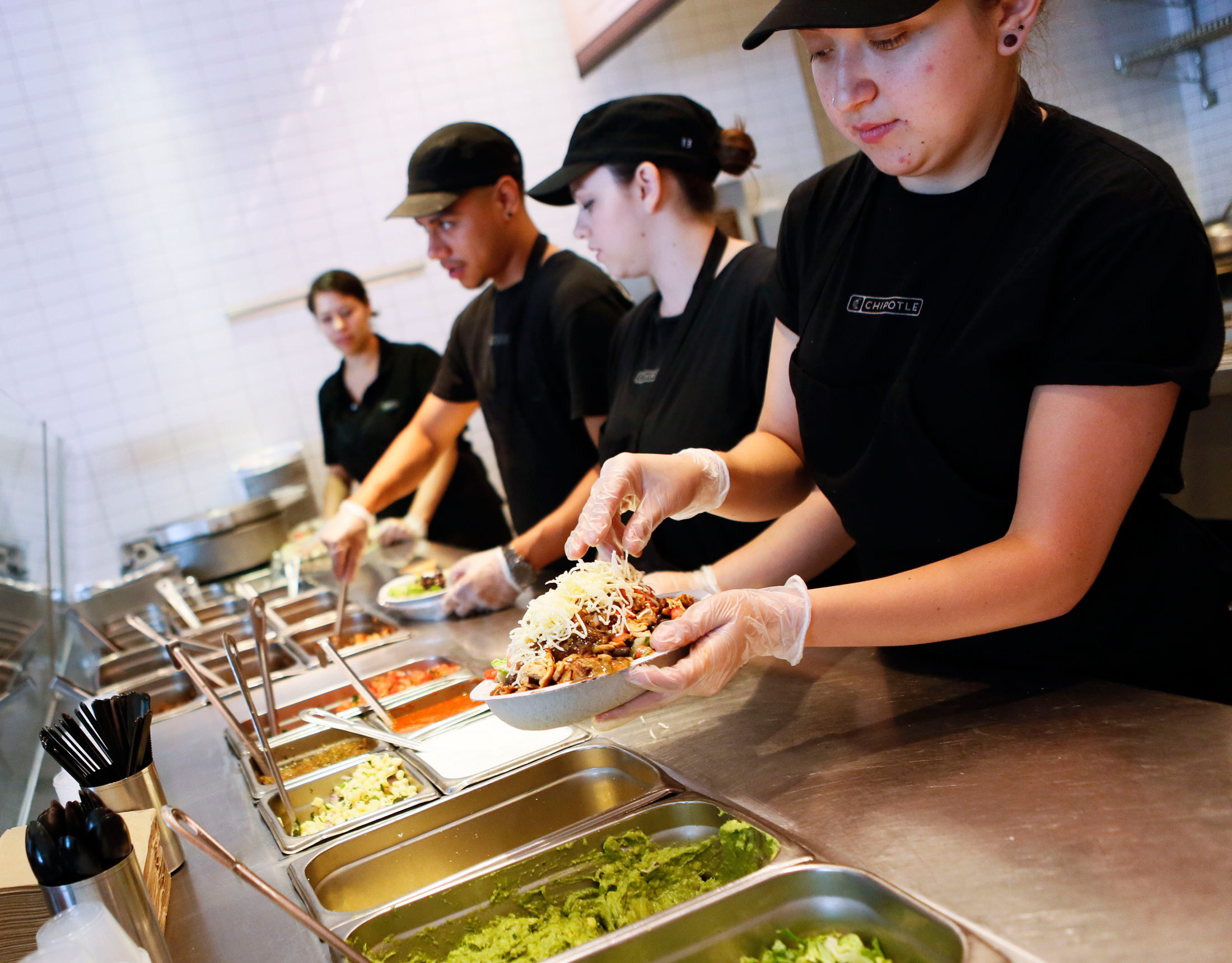 Employees prepare orders at a Chipotle Mexican Grill in Hollywood, California.
