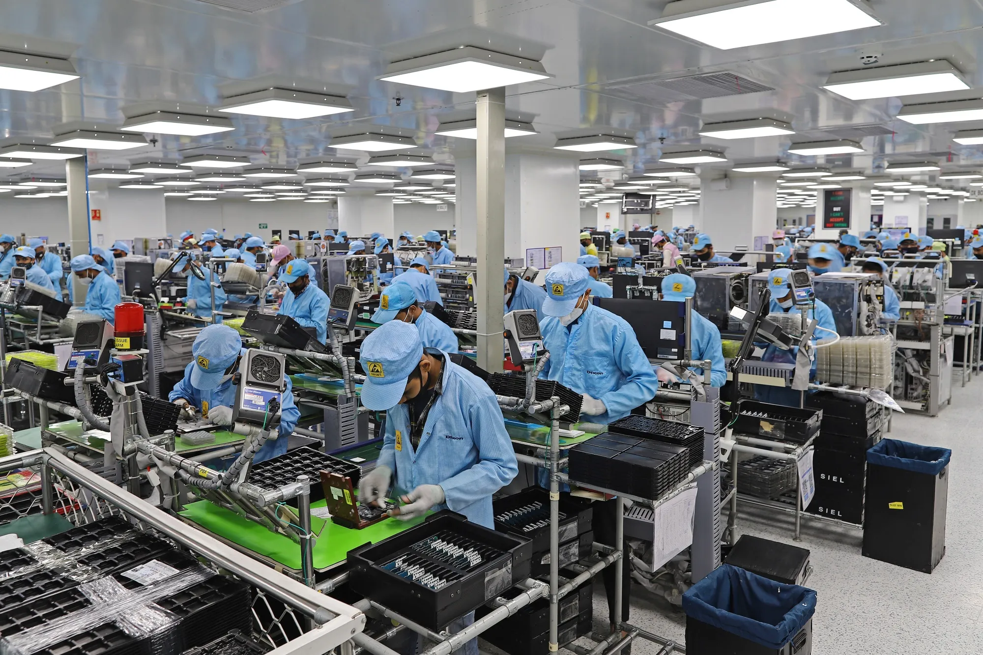 Workers assemble mobile phones at a Dixon Technologies factory in Noida, Uttar Pradesh, India.