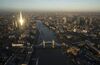 Tower Bridge spans the River Thames as skyscrapers.