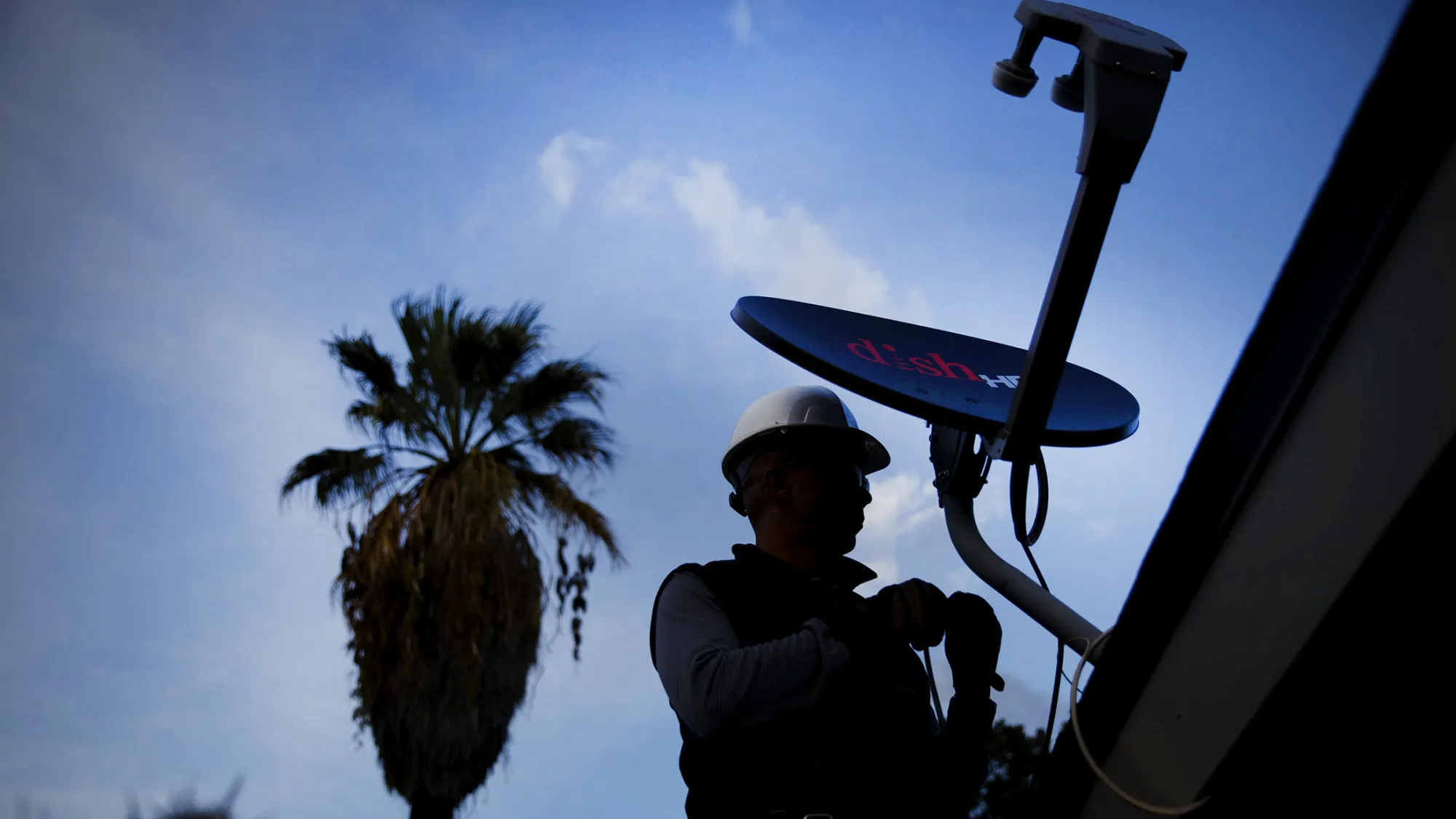 A Dish Network Corp. field service specialist installs a satellite television system at a residence in Downey, Calif.
