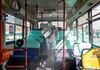 A worker wearing a protective suit sprays disinfectant inside a bus at a depot in the Eunpyeong district of Seoul, South Korea, on Feb. 24, 2020.