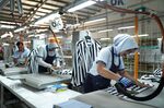 Workers iron clothing at the Sri Rejeki Isman PT factory in Solo, Central Java, Indonesia.