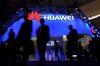 Visitors pass in front of the Huawei's stand on the first day of the Mobile World Congress in Barcelonaon.
