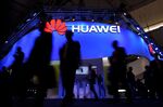 Visitors pass in front of the Huawei's stand on the first day of the Mobile World Congress in Barcelonaon.