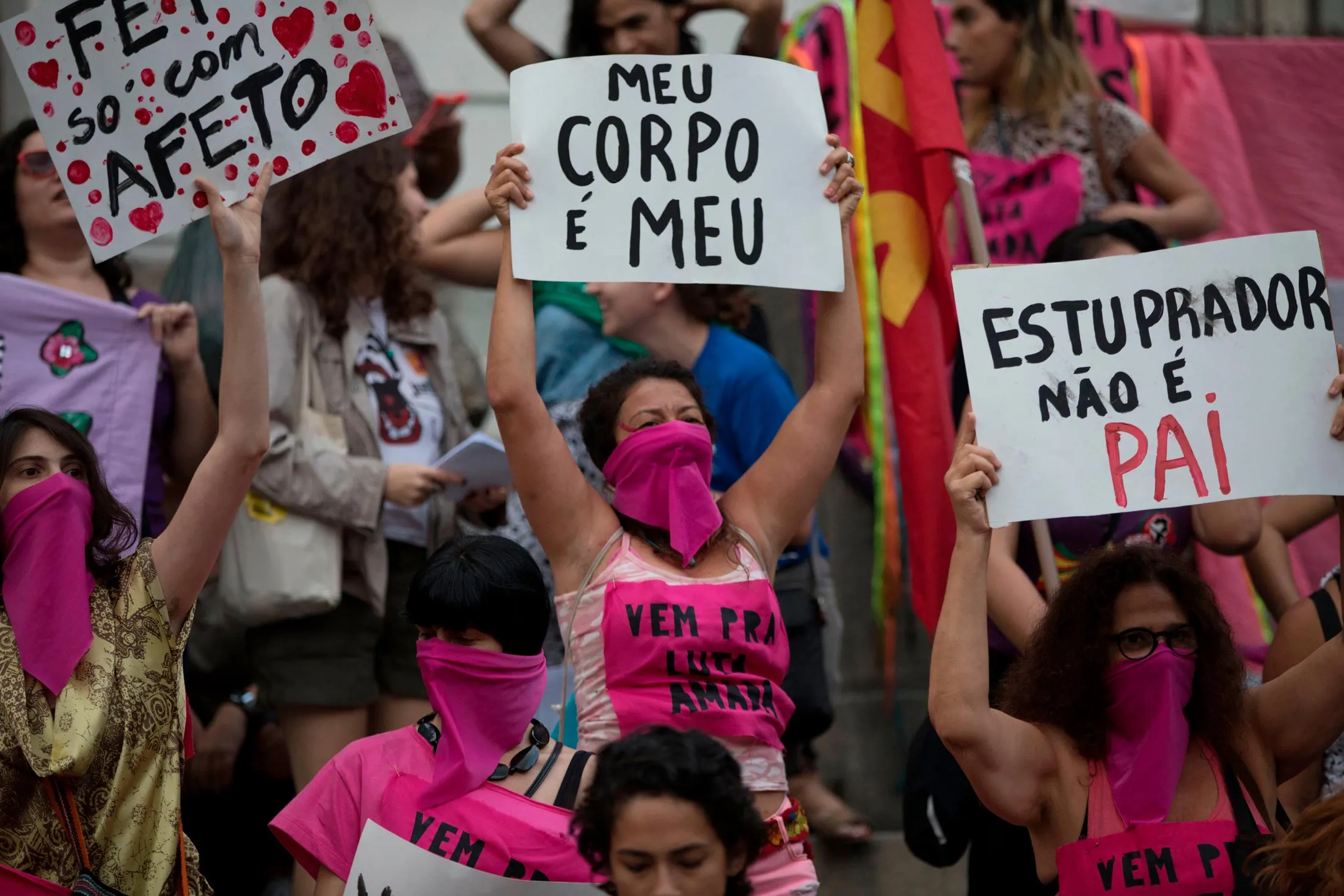 Women wearing pink masks protest violence against women in Rio de Janeiro in November.