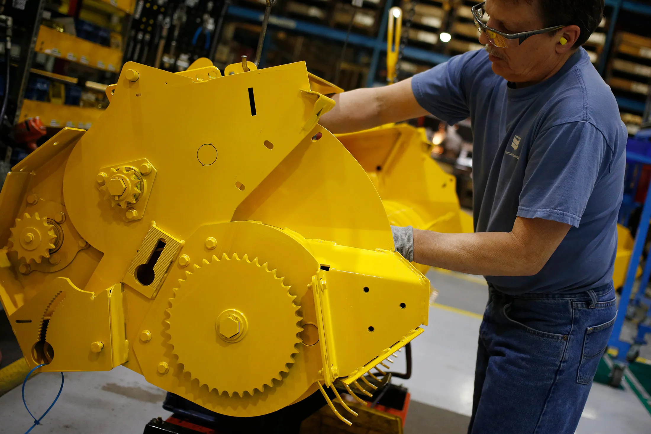 A worker assembles components for a round baler at a factory in New Holland, Pennsylvania.
