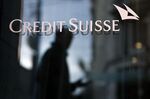 A pedestrian walks by a Credit Suisse Group AG bank branch in Geneva, Switzerland.