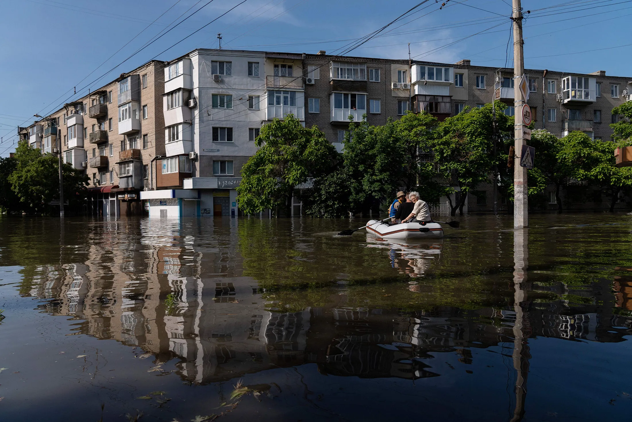 Ukrainian security forces transport local residents in a boat during an evacuation from a flooded area in Kherson&nbsp;following damages sustained at Kakhova hydroelectric power plant dam on June 7.