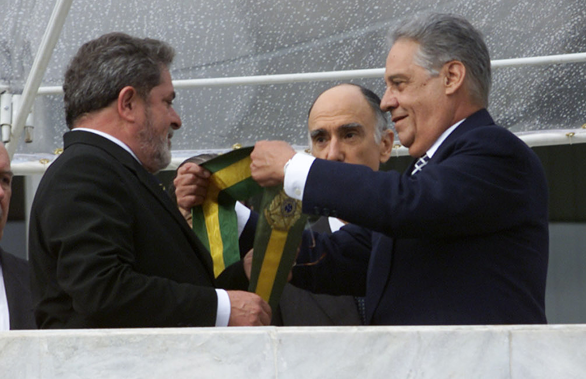 Luiz Inacio Lula da Silva receives the presidential sash from Fernando Henrique Cardoso on January 1, 2003.