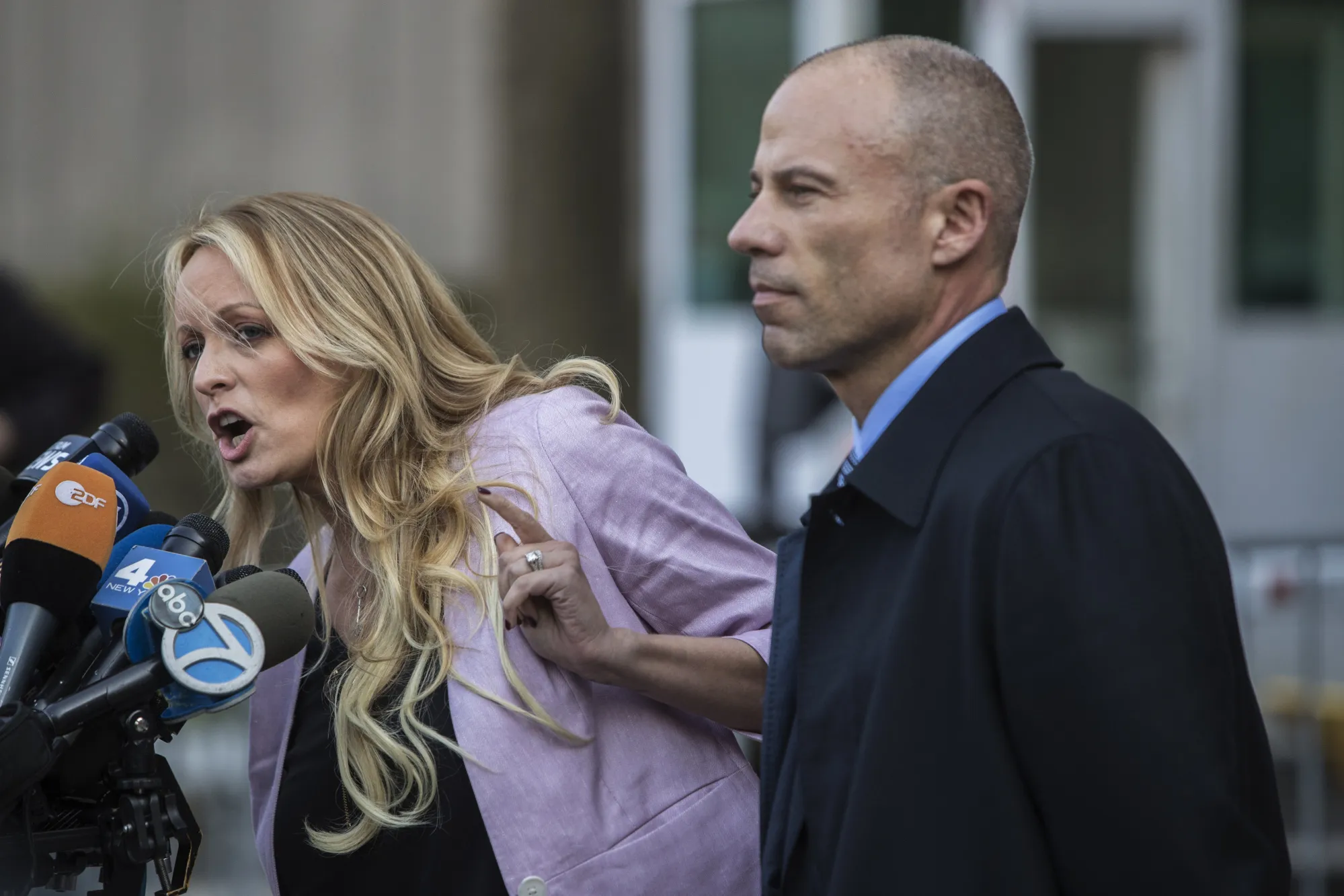Stormy Daniels, left, speaks to members of the media while attorney Michael Avenatti listens outside federal court in New York on April 16, 2018.