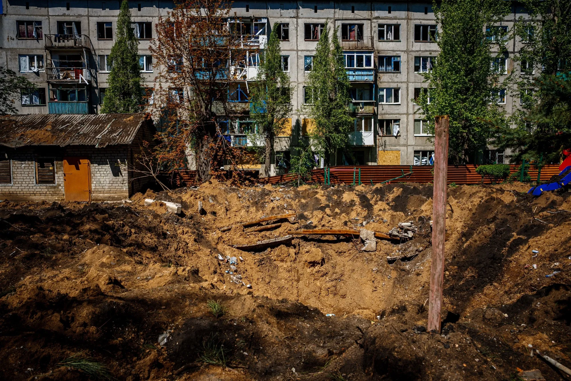 Damaged residential buildings and crater following a Russian missile strike&nbsp;in Chasiv Yar, Ukraine.
