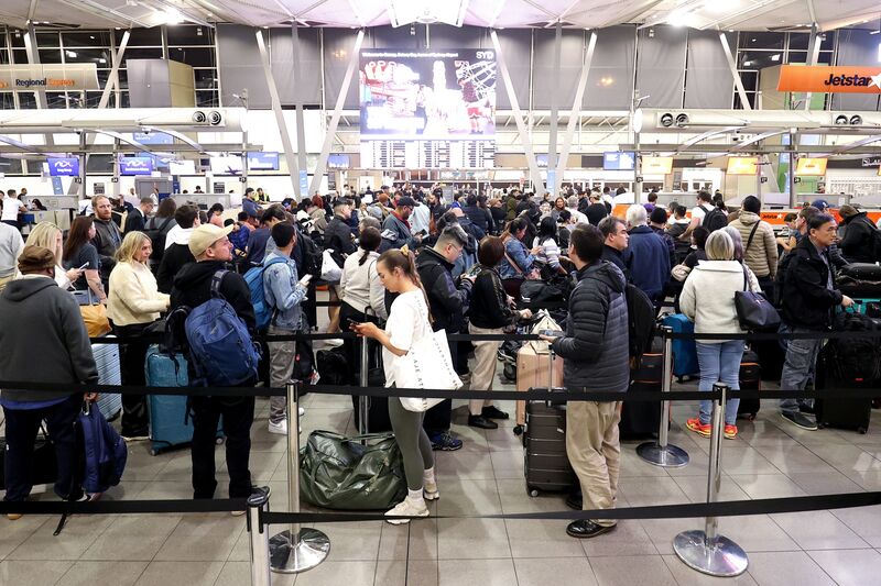 Passengers queue at Jetstar Airways' check-in area at Sydney Airport on  July 19