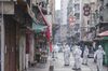 Government workers work in an area under lockdown in the Jordan area of Hong Kong, Jan. 23 