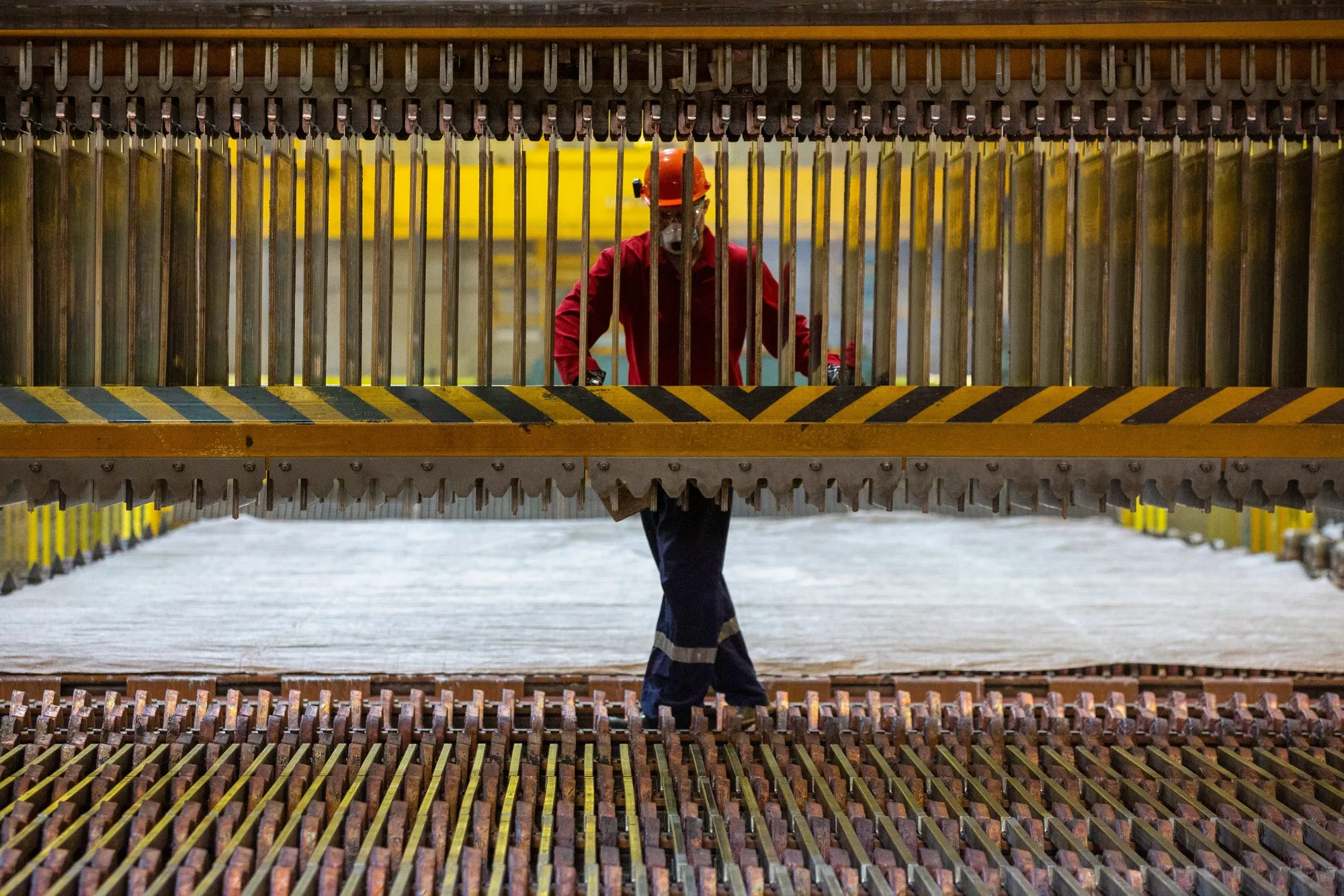 A worker inspects copper&nbsp;at a refinery&nbsp;operated by Ural Mining and Metallurgical Co. in Verkhnyaya Pyshma, Russia.&nbsp;
