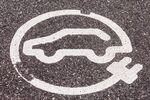 Painted road sign indicating electric car charging station