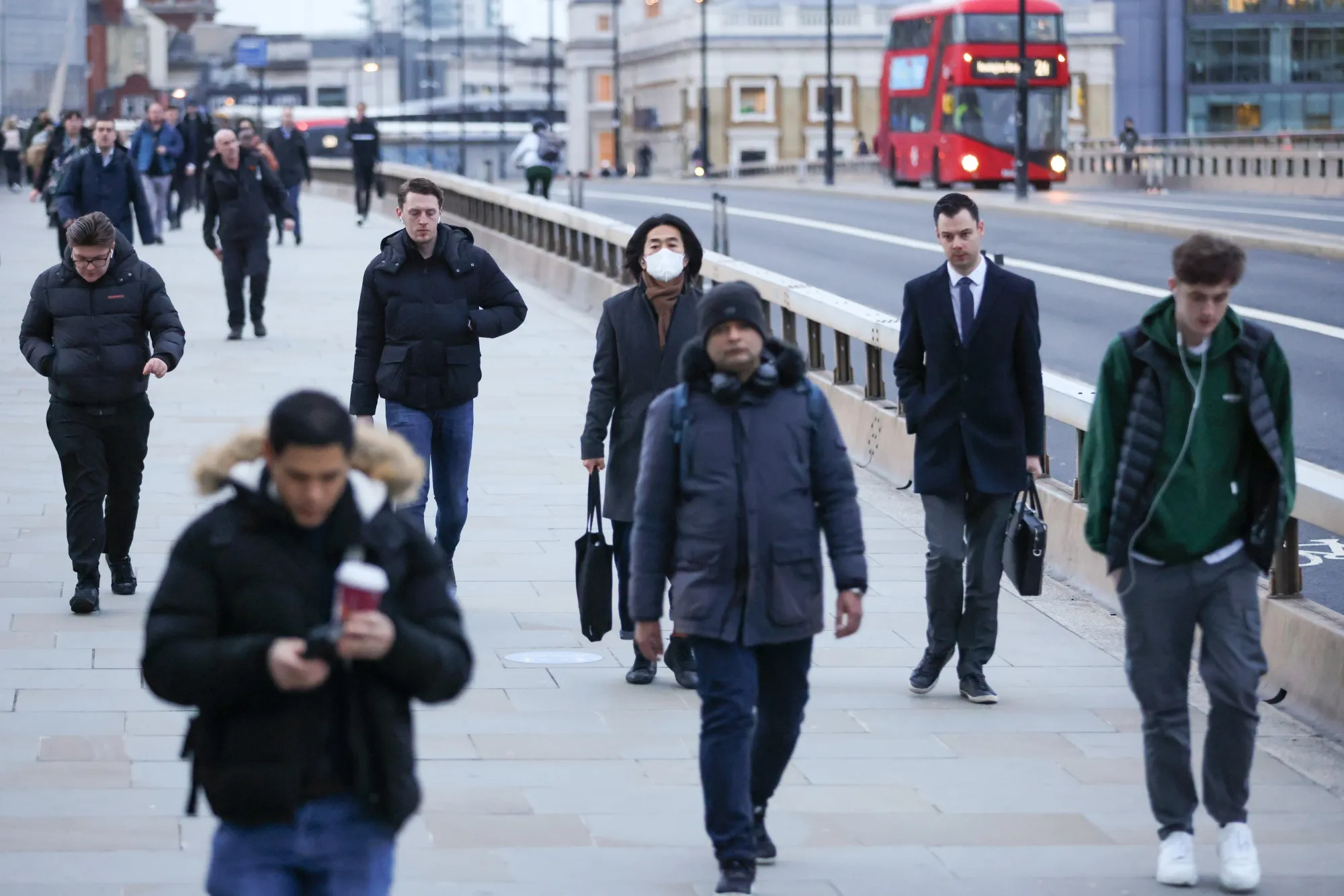 Morning commuters cross London Bridge towards the City of London, U.K.