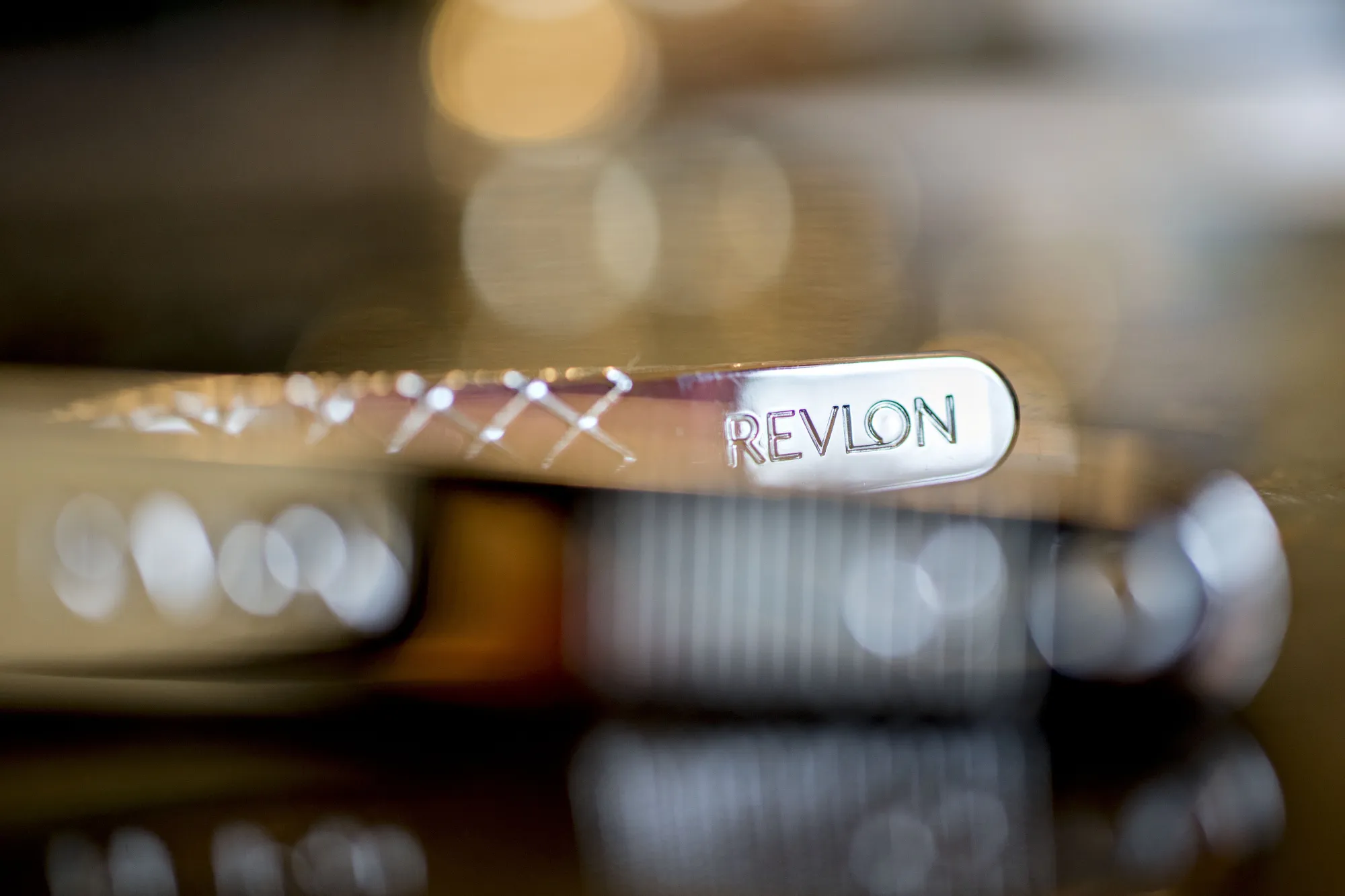 The Revlon Inc. logo is seen on the end of a pair of nail clippers.