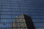 A building is reflected in the John Hancock Tower, Bain Capital LLC's headquarters in Boston, Massachusetts, U.S.,