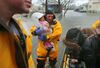 A rescue worker holds a crying baby rescued with her mother from a flooded home on Post Island Road in the Houghs Neck section of Quincy, Mass. during on March 2. 