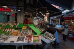A vendor arranges a display at a fishmonger's stall in Istanbul, Turkey.