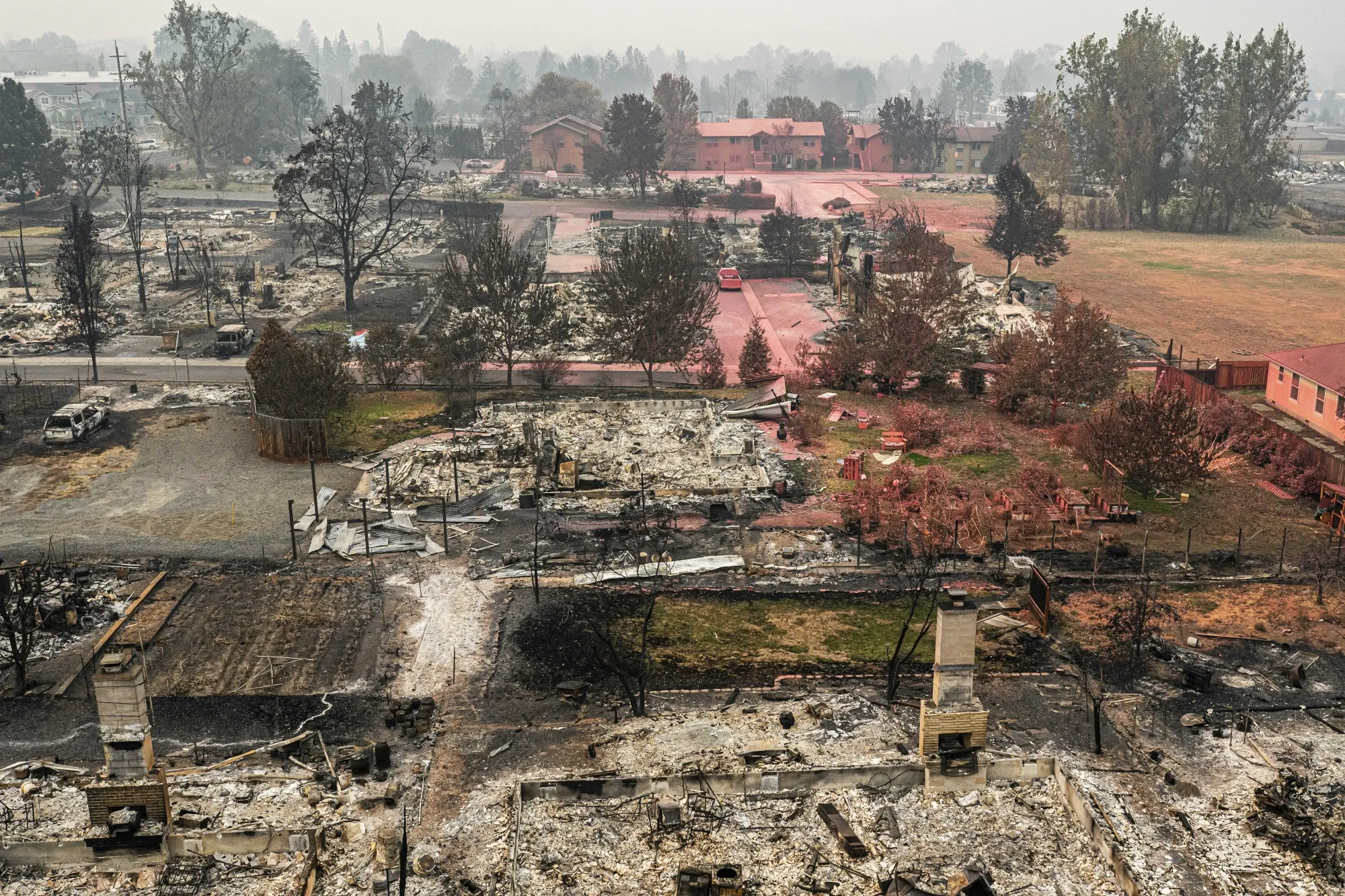 The remains of homes and vehicles line a residential street in Talent, Oregon, in Sept.,&nbsp;2020.