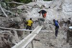 Men work with the gold laced sands in the middle of the equatorial forest in Mayibouth, north east Gabon.