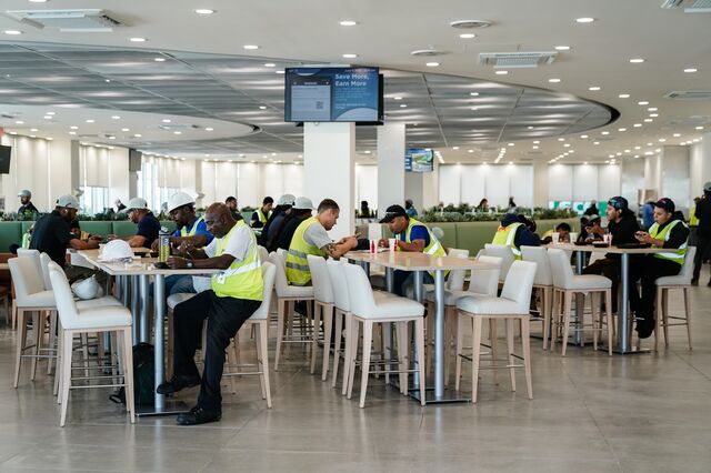 Employees and contractors are seen in the cafeteria at the Hyundai Metaplant.
