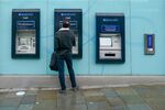 A person stands at&nbsp;an ATM at a Barclays Plc branch in Newcastle, UK.&nbsp;