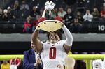 Wisconsin running back Braelon Allen (0) holds up the trophy after Wisconsin defeated Arizona State in the Las Vegas Bowl NCAA college football game Thursday, Dec. 30, 2021, in Las Vegas. (AP Photo/L.E. Baskow)