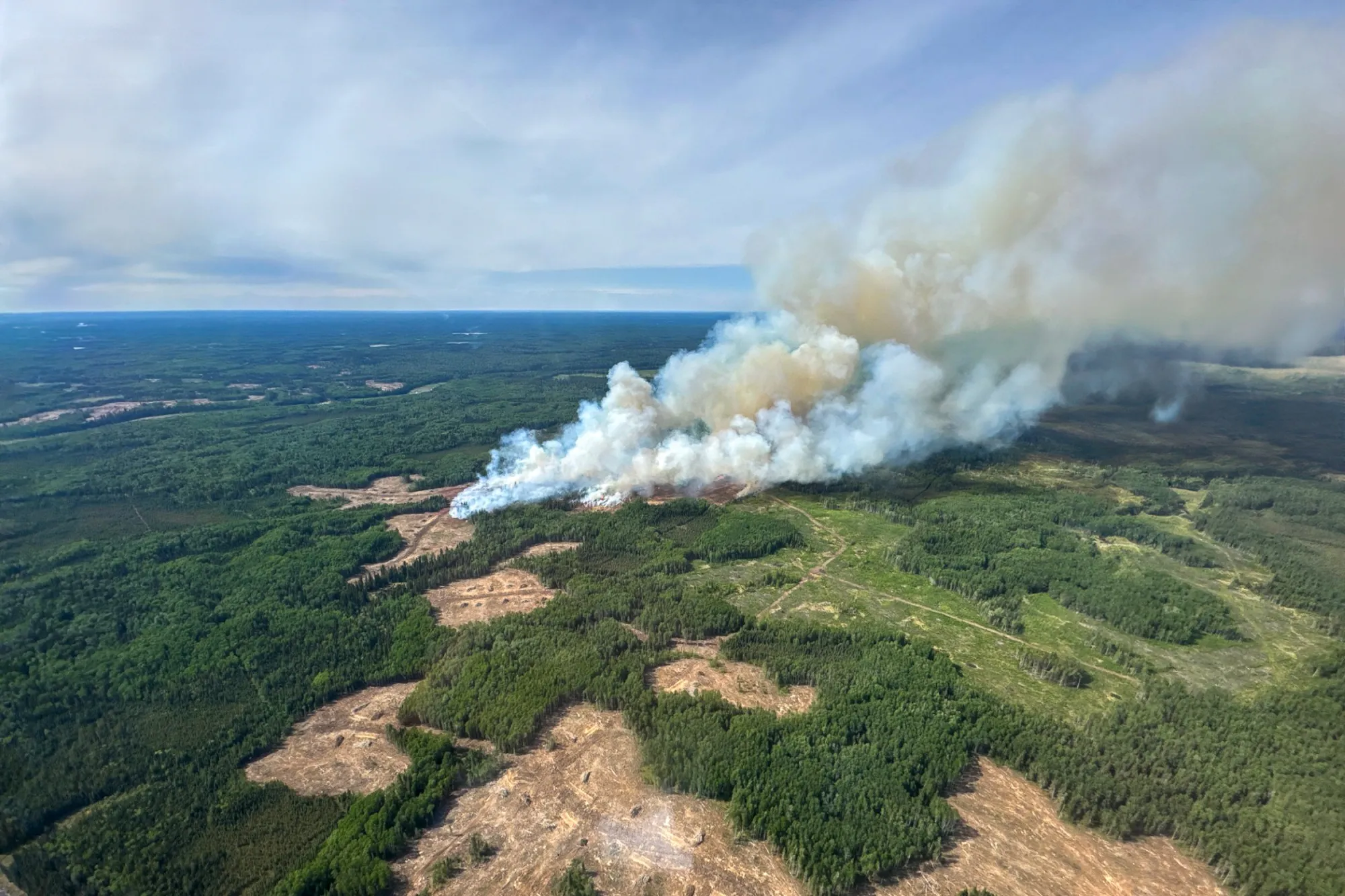 Smoke rises from Edith Lake wildfire SWF076, which forced the evacuation of the nearby town of Swan Hills, Alberta, Canada.
